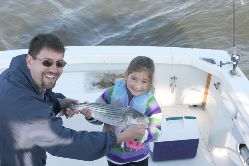 little girl holding rockfish