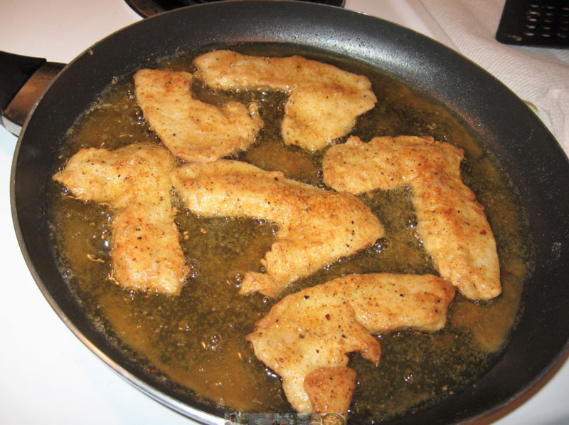 fresh fish sizzling in the frying pan