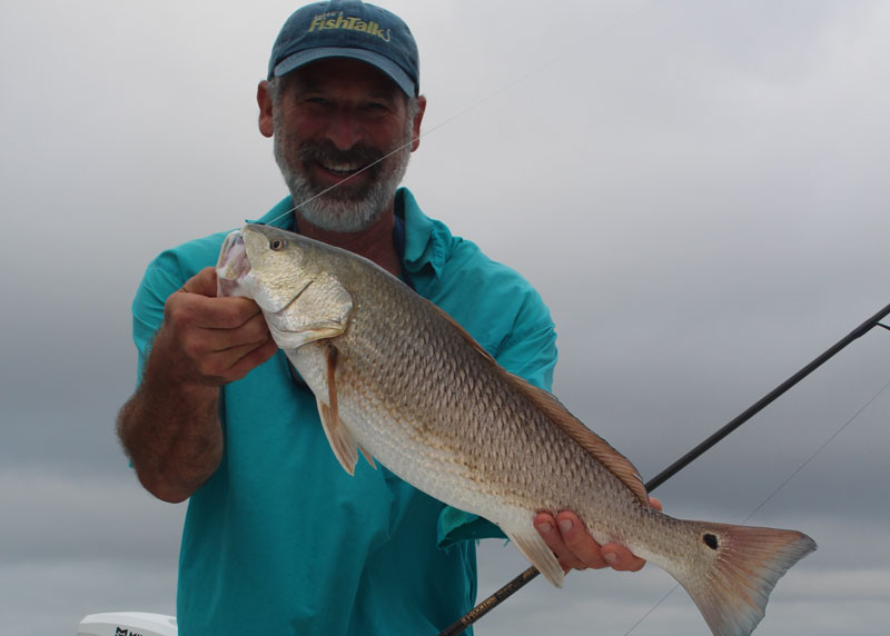 angler with a red drum caught in the chesapeake bay