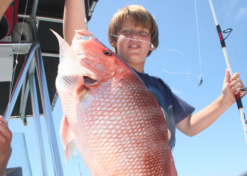kid catching a red snapper