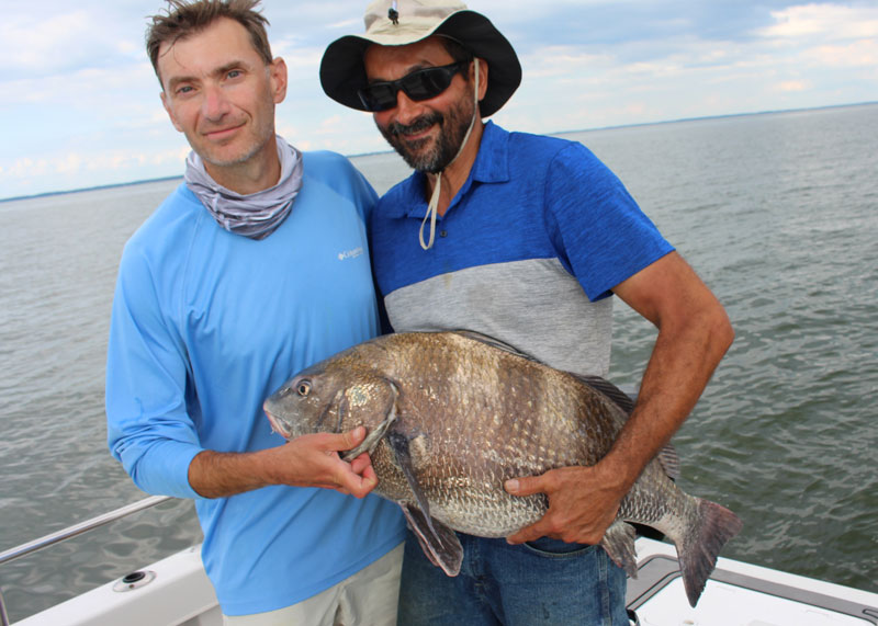 anglers with a small black drum they caught