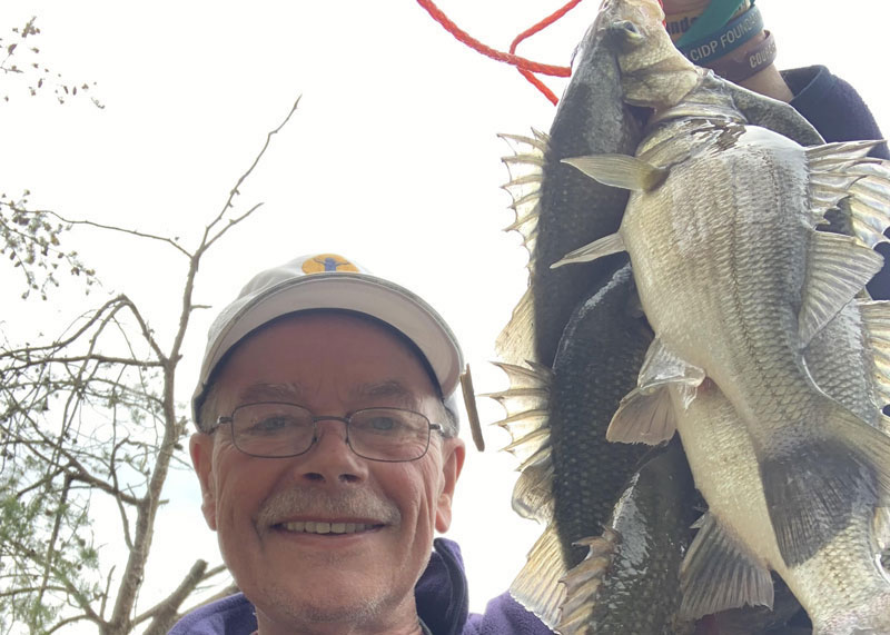 angler with a stringer of white perch
